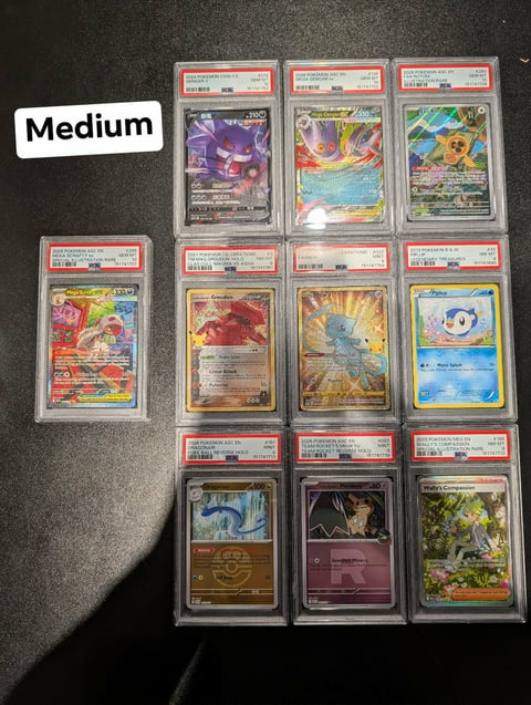 Collection of ten graded Pokémon trading cards in protective cases arranged on dark surface, labeled Medium