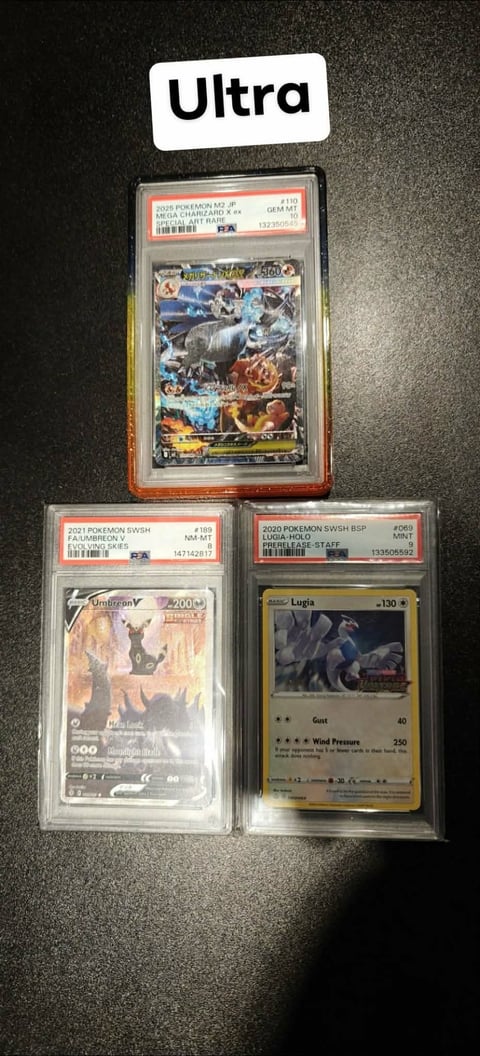 Three graded Pokemon trading cards in protective cases displayed on dark surface, with Ultra label above